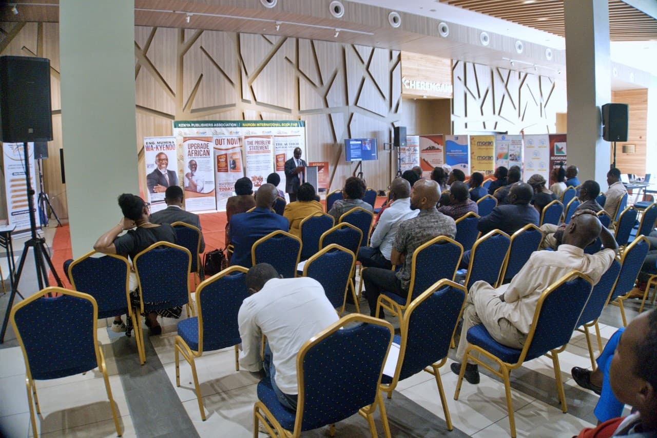 Audience listening to a speaker at the podium during the book launch