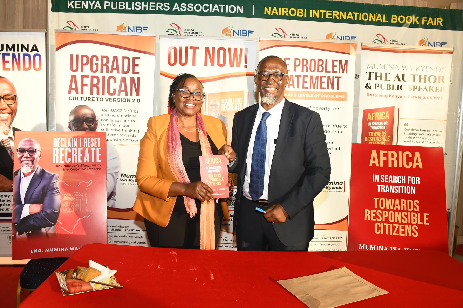Eng. Mumina Wa-Kyendo presenting a copy of Africa In Search for Transition to a guest at the Nairobi International Book Fair