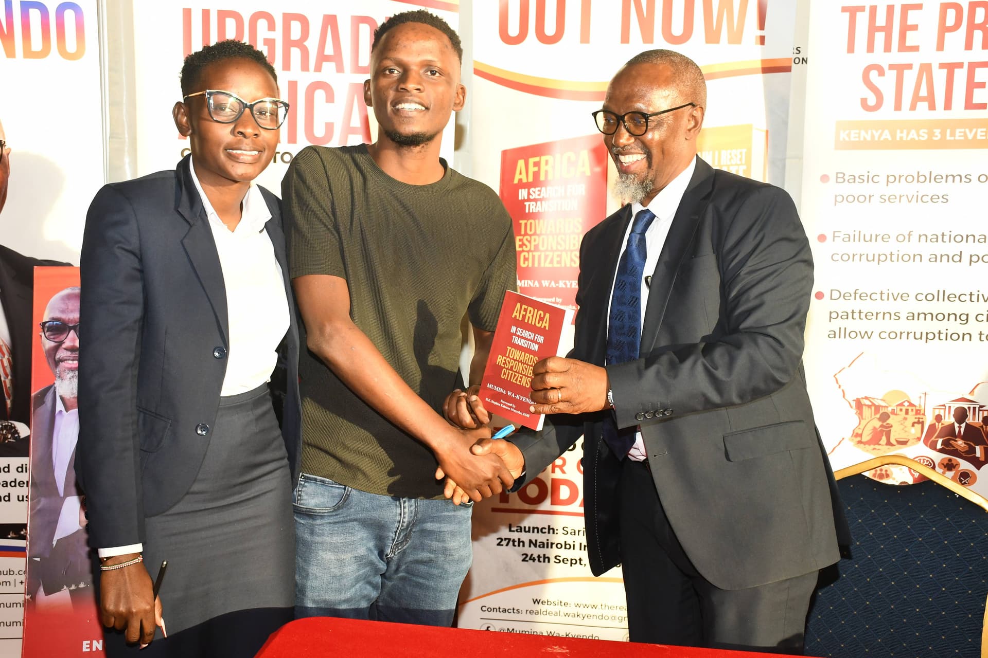Eng. Mumina Wa-Kyendo congratulating readers with a signed copy